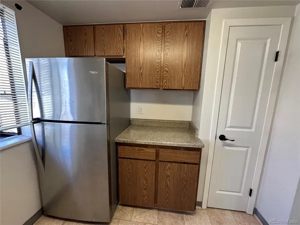 a kitchen with metallic refrigerator freezer and a dishwasher