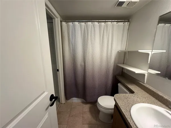 a bathroom with a sink a toilet and tub