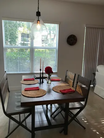 a view of a dining room with furniture and window