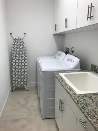 a large bed sitting in a bedroom next to a lamp