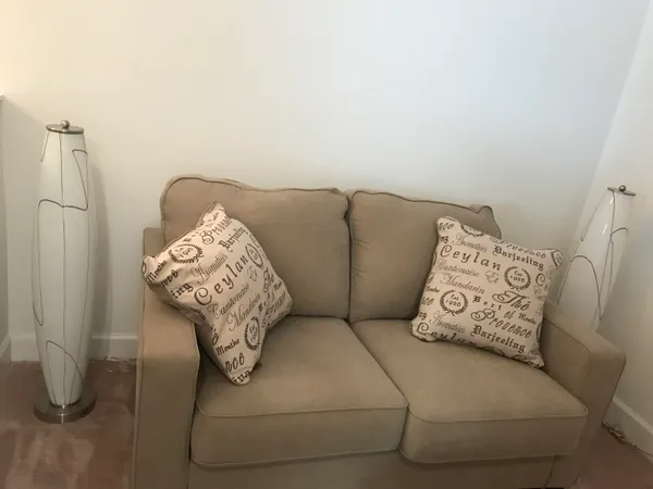 a living room with furniture a rug and a window