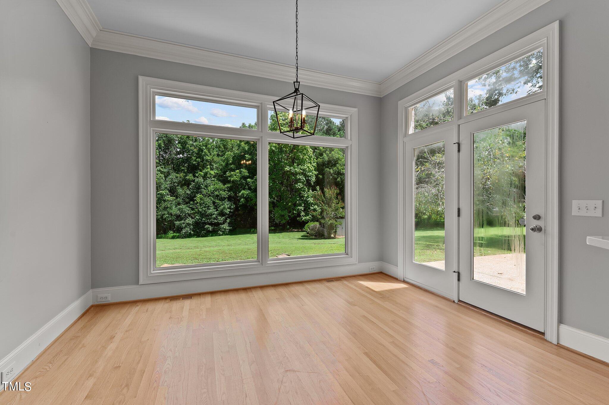 1609 Old Keith Road Wake Forest, NC 27587 - Photo 24 of 81 a view of an empty room with wooden floor and a large window