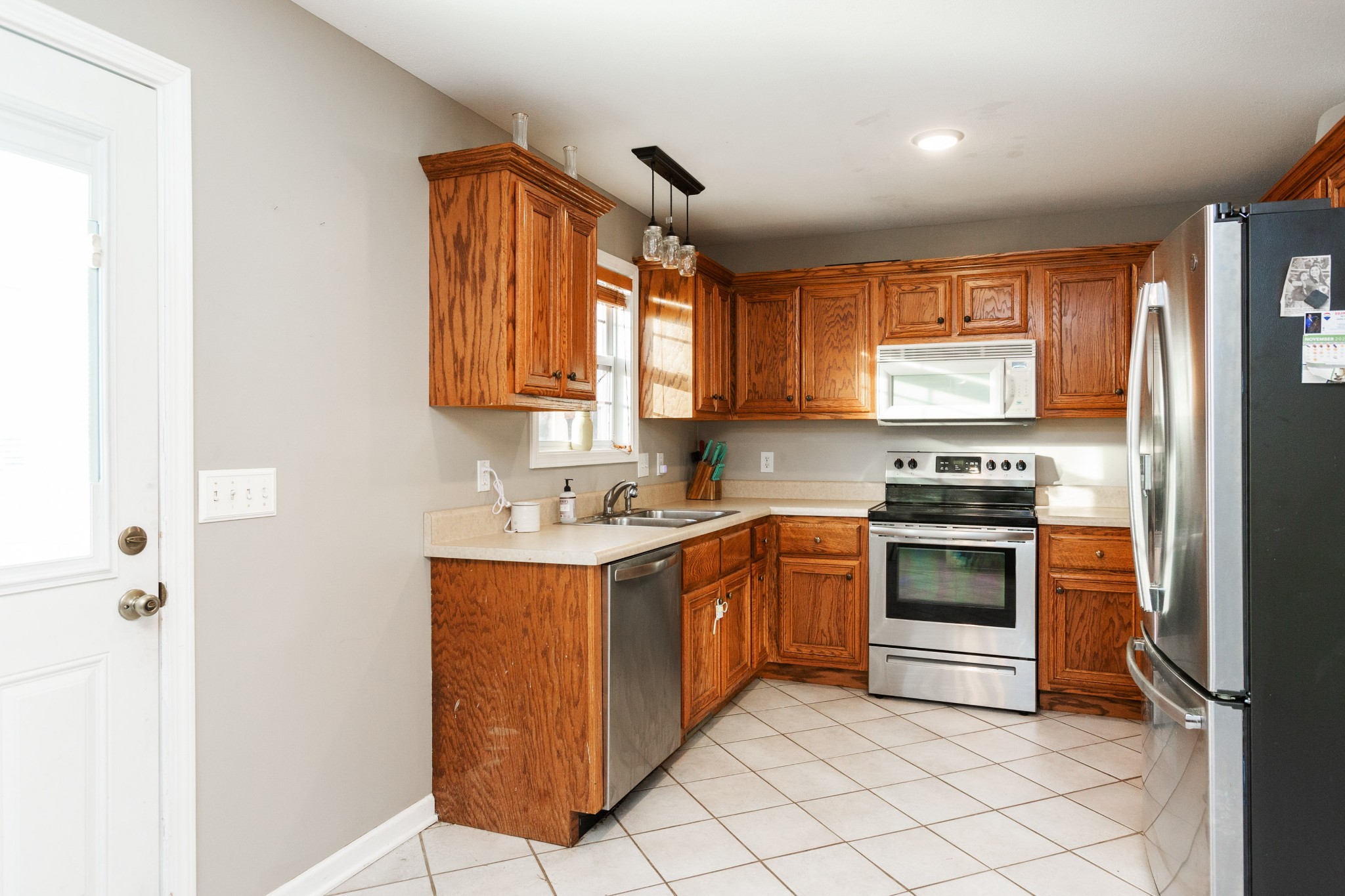 4382 Airport Road Springfield, TN 37172 - Photo 9 of 31 a kitchen with stainless steel appliances granite countertop a stove a sink and a refrigerator