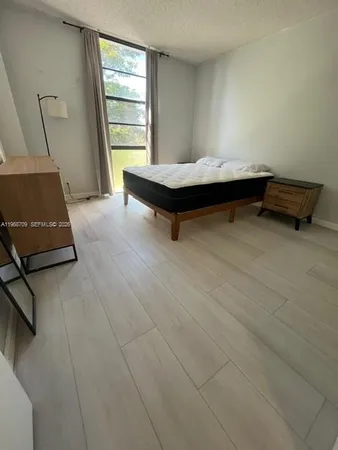 a room with pool table and windows