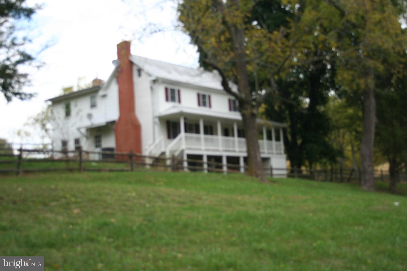 6028 Old Bohn Road Mount Airy, MD 21771 - Photo 1 of 9 a view of a house with a big yard and large trees