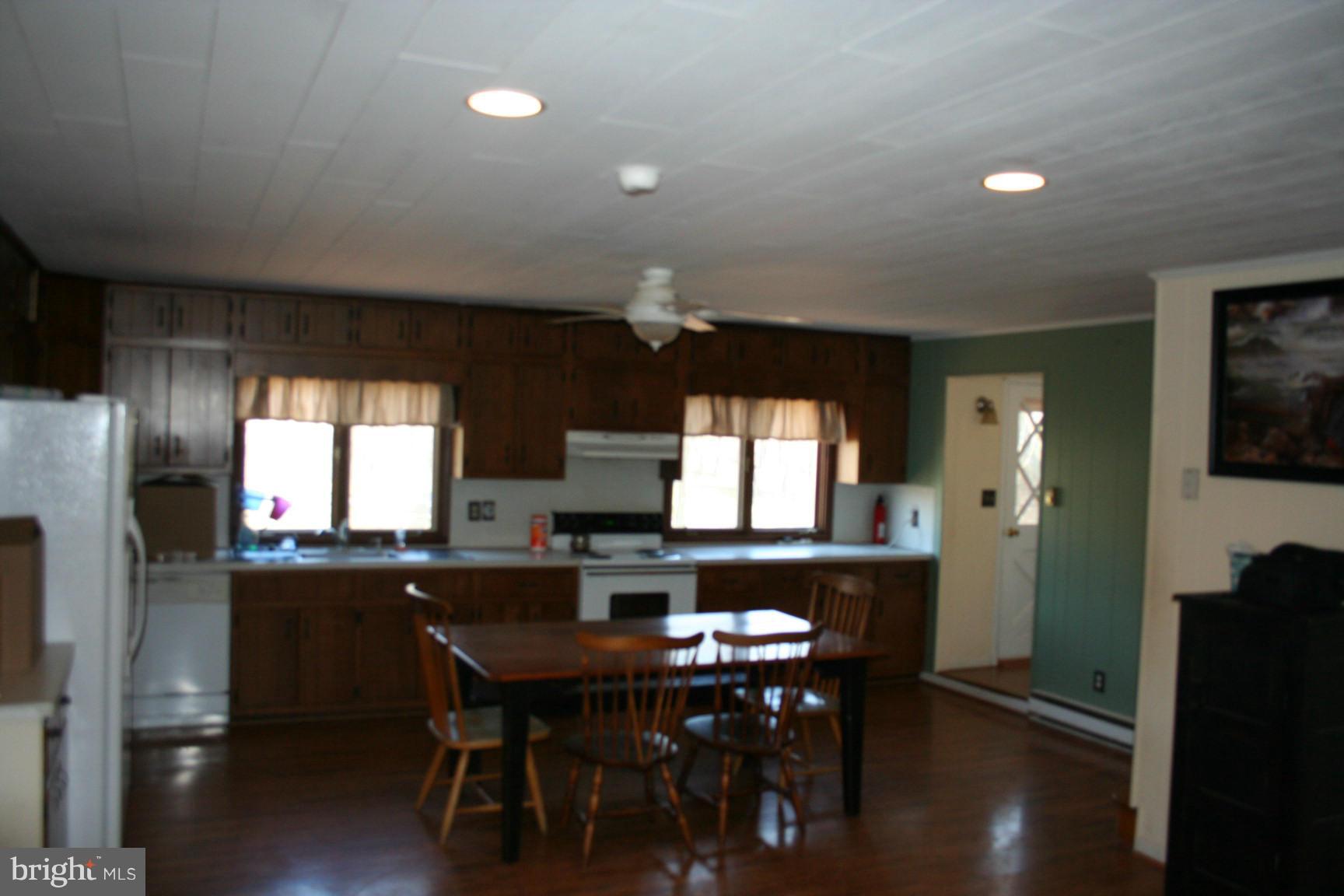 6028 Old Bohn Road Mount Airy, MD 21771 - Photo 4 of 9 a kitchen with a table chairs refrigerator and window