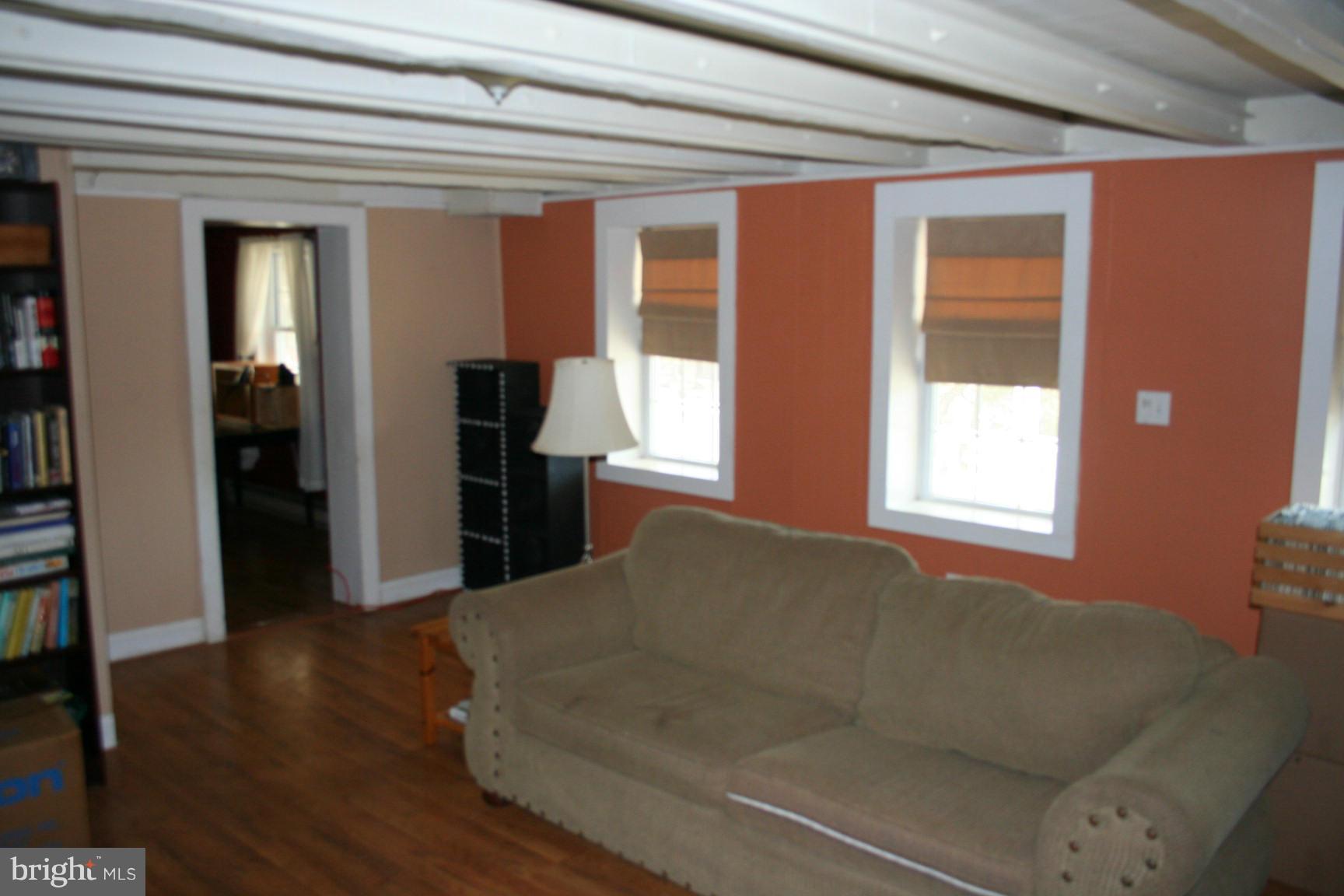 6028 Old Bohn Road Mount Airy, MD 21771 - Photo 7 of 9 a living room with a large window and a refrigerator