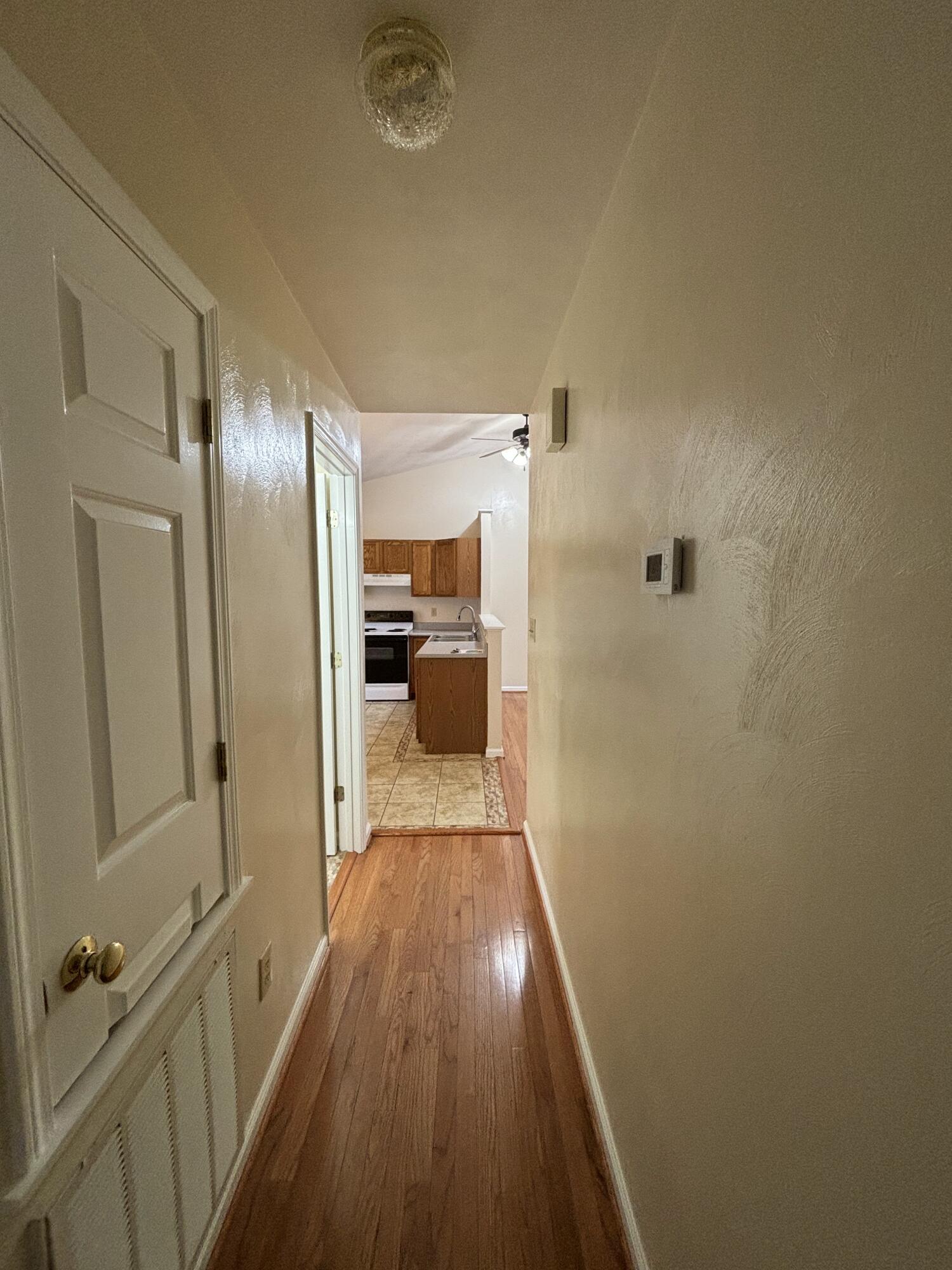2719 Bandy Road Roanoke, VA 24014 - Photo 21 of 33 a view of a hallway with wooden floor and a bathroom