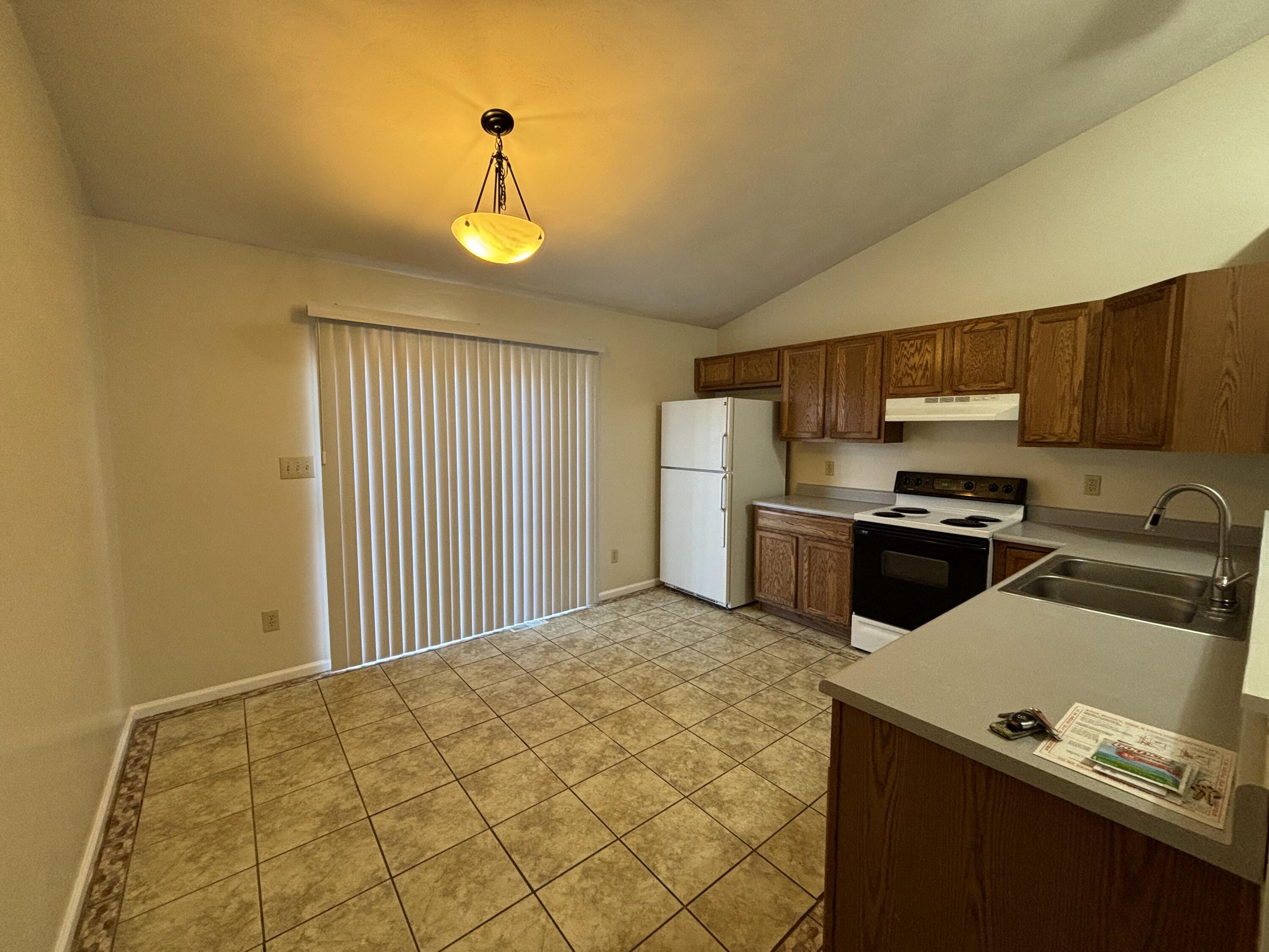 2719 Bandy Road Roanoke, VA 24014 - Photo 6 of 33 a kitchen with a refrigerator and a stove top oven