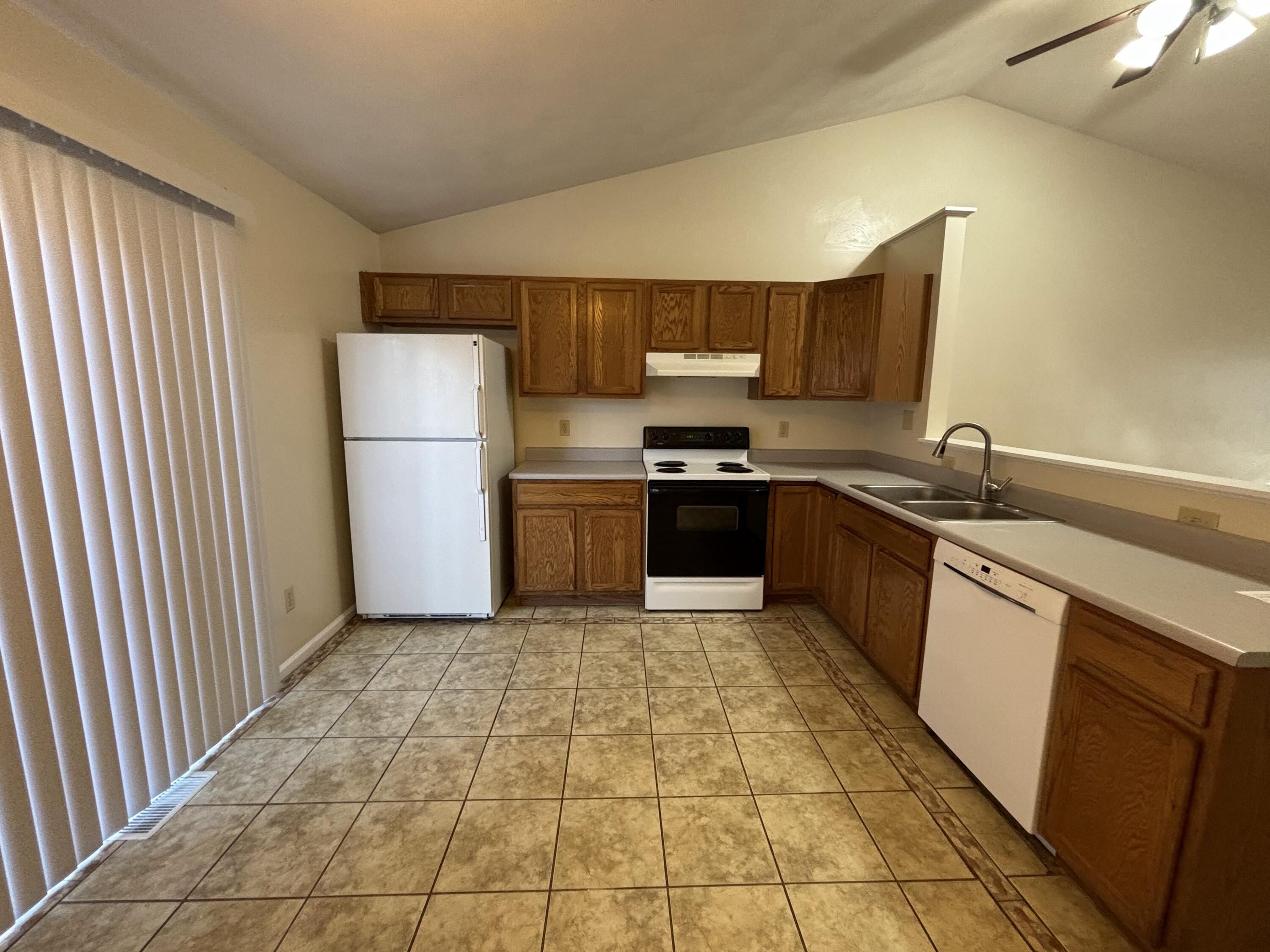 2719 Bandy Road Roanoke, VA 24014 - Photo 7 of 33 a kitchen with a sink a stove top oven and refrigerator