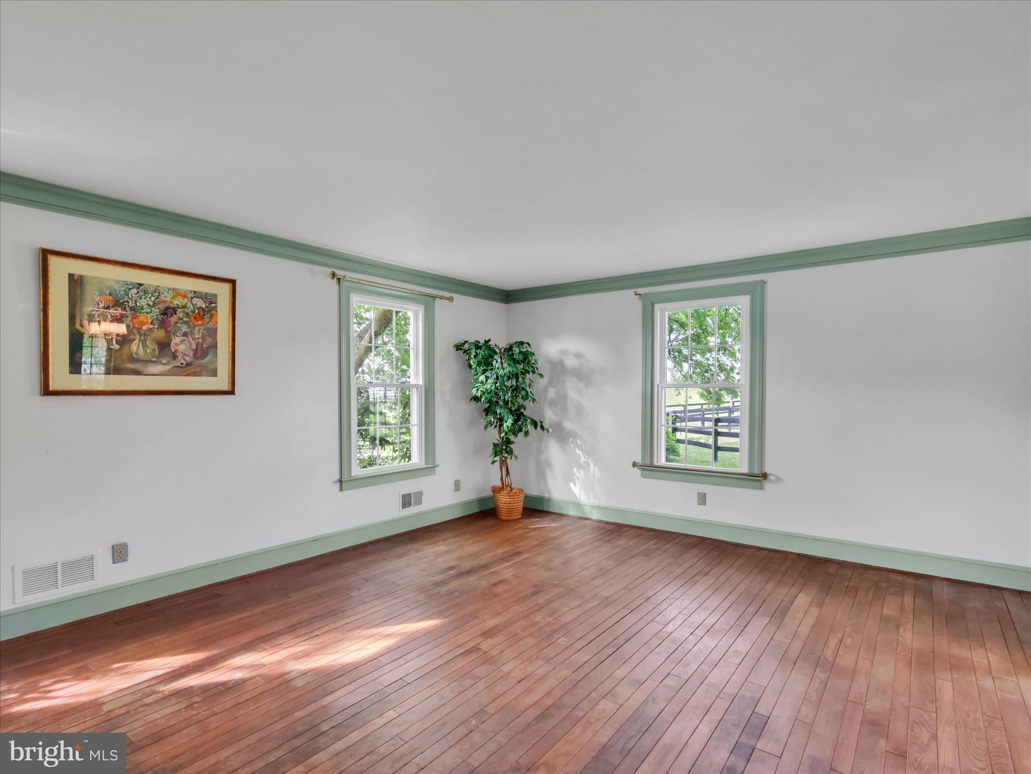 19255 Telegraph Springs Road Purcellville, VA 20132 - Photo 31 of 107 a view of an empty room with wooden floor and a window