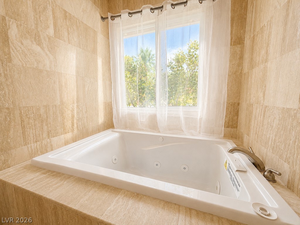 3010 East Viking Road Las Vegas, NV 89121 - Photo 18 of 48 Relaxation awaits in this spa-like bathroom, complete with a jetted soaking tub and large window for natural light.