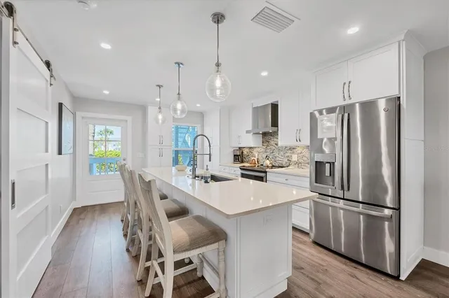 a kitchen with counter top space a sink cabinets and stainless steel appliances
