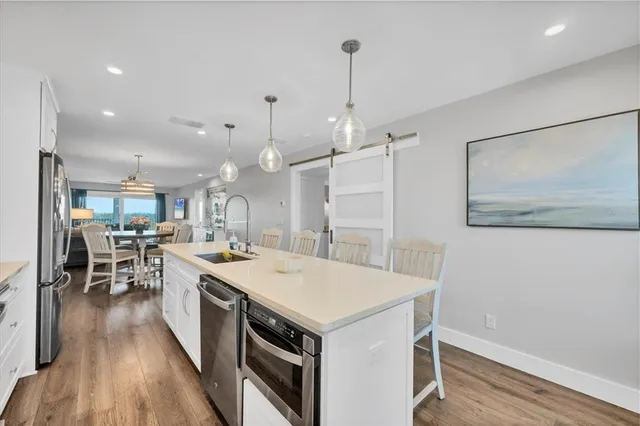 a large kitchen with a table and chairs