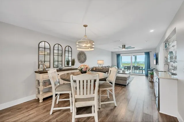 a view of a dining room with furniture wooden floor and chandelier