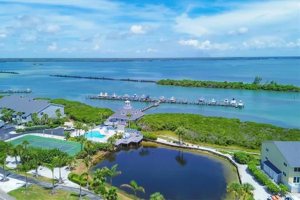 an aerial view of residential building with outdoor space and ocean view