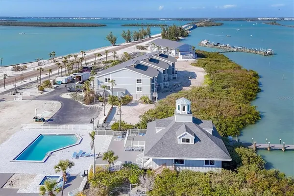 a aerial view of a house with a garden and lake view