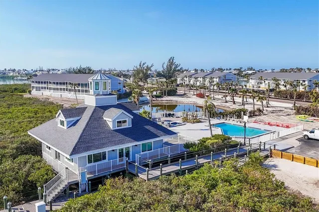 a view of a lake with lawn chairs