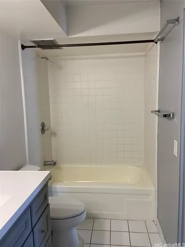 a bathroom with a shower a bathtub and a toilet
