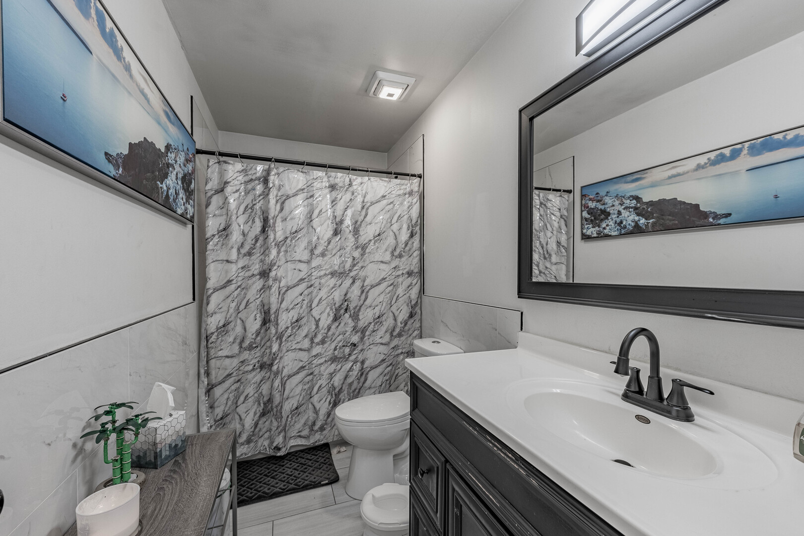 7747 West 62nd Street Summit, IL 60501 - Photo 12 of 23 a bathroom with a sink a toilet and shower curtain
