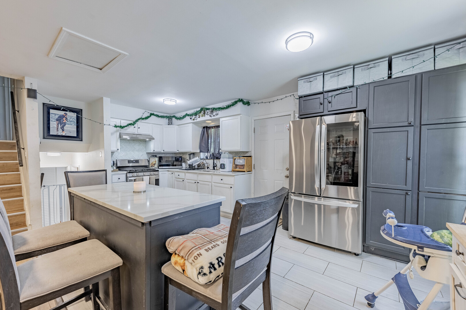 7747 West 62nd Street Summit, IL 60501 - Photo 4 of 23 a kitchen with refrigerator and chairs