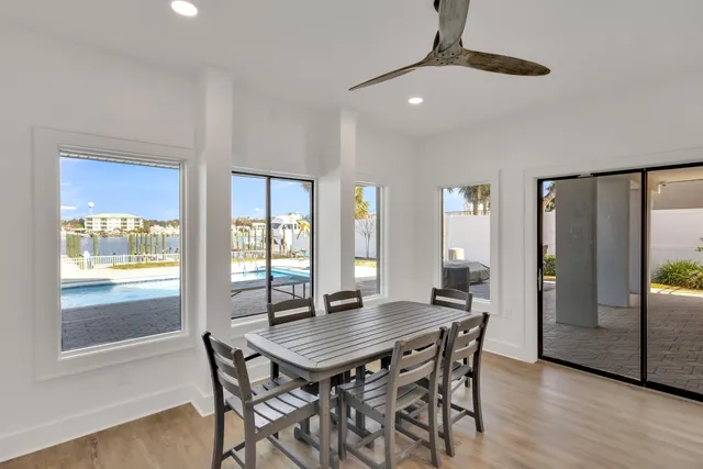 a kitchen with granite countertop white cabinets white stainless steel appliances and a sink