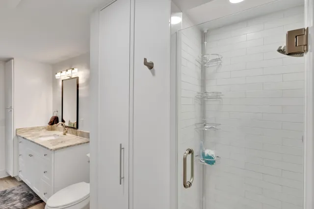 a bedroom with a balcony a bed and a flat screen tv