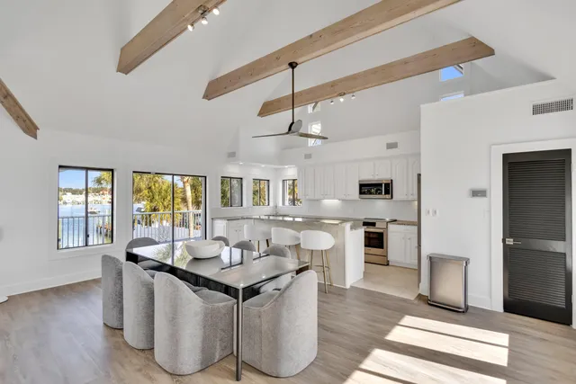 a view of a balcony with wooden floor and outdoor seating