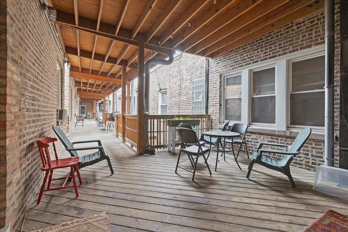 2453 North Clark Street, Unit 3 Chicago, IL 60614 - Photo 11 of 11 a view of a patio with table and chairs and wooden floor