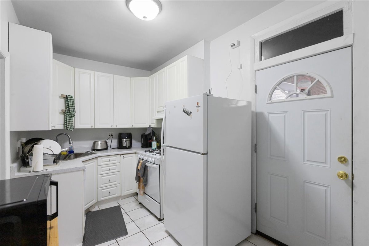 2453 North Clark Street, Unit 3 Chicago, IL 60614 - Photo 2 of 11 a white refrigerator freezer sitting inside of a kitchen