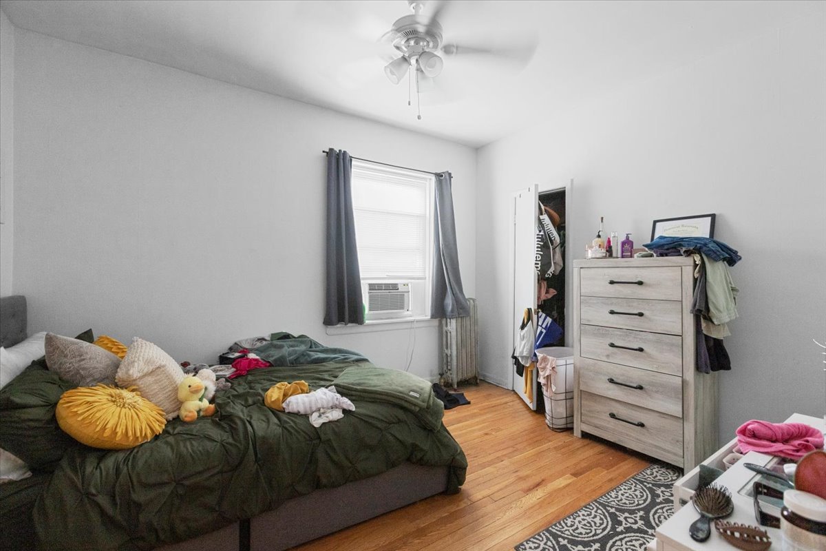 2453 North Clark Street, Unit 3 Chicago, IL 60614 - Photo 8 of 11 a bedroom with a bed and a window