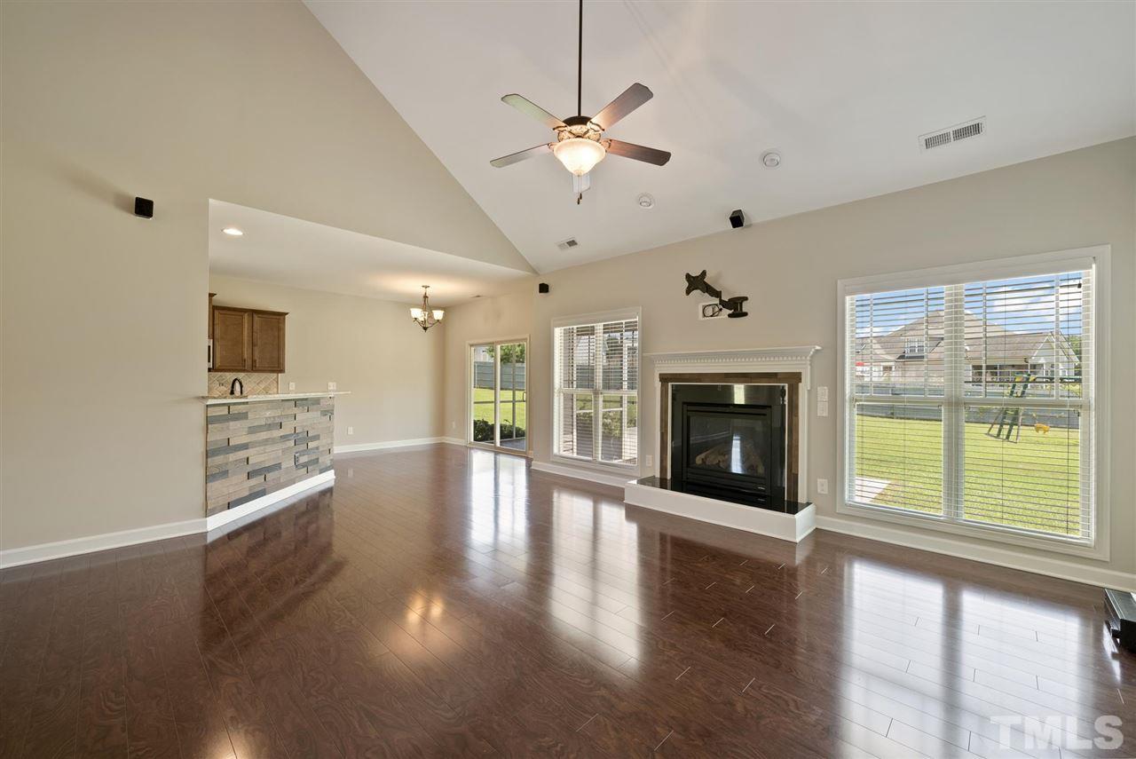 95 South Sunset Ridge Drive Willow Spring, NC 27592 - Photo 13 of 24 a view of a big room with wooden floor a fireplace and windows