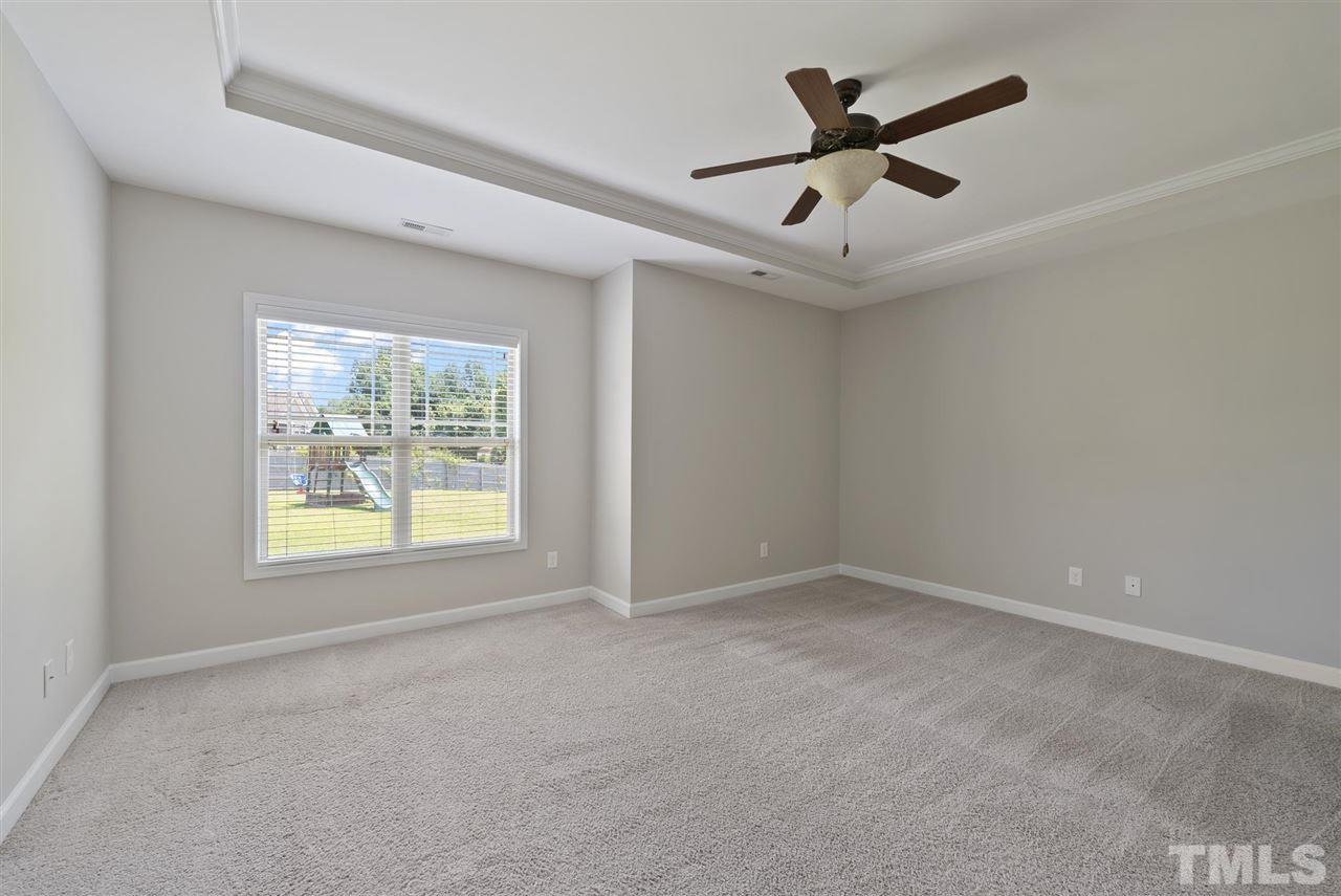 95 South Sunset Ridge Drive Willow Spring, NC 27592 - Photo 14 of 24 an empty room with ceiling fan and windows