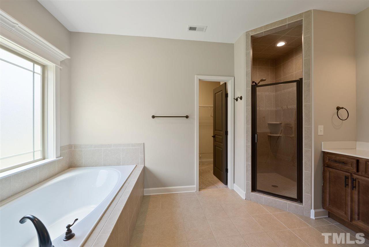 95 South Sunset Ridge Drive Willow Spring, NC 27592 - Photo 16 of 24 a bathroom with a tub and shower