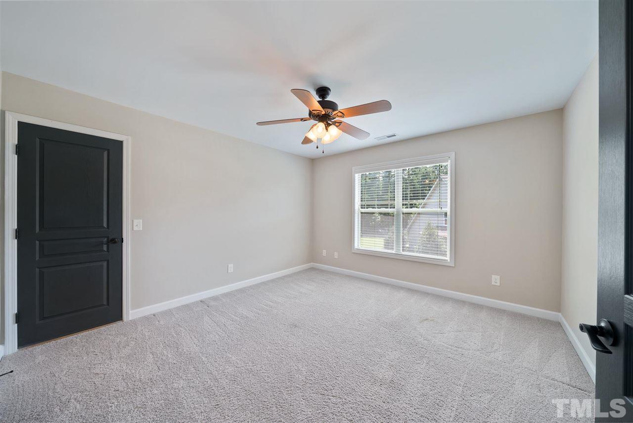 95 South Sunset Ridge Drive Willow Spring, NC 27592 - Photo 19 of 24 a view of a room with a ceiling fan and a window