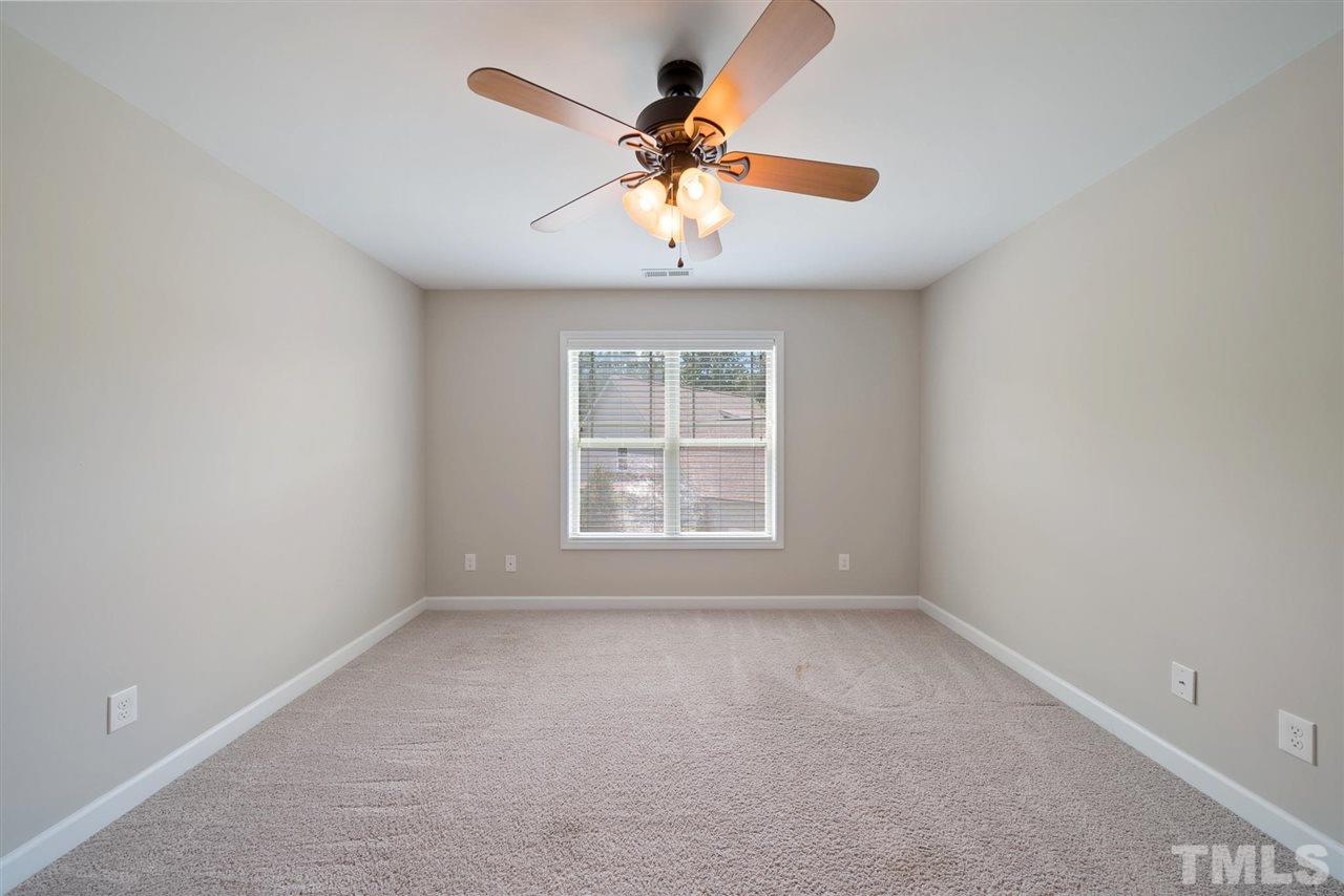 95 South Sunset Ridge Drive Willow Spring, NC 27592 - Photo 20 of 24 an empty room with a window and a fan