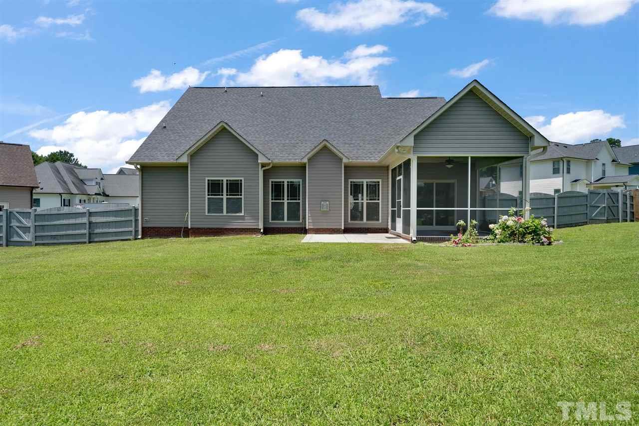 95 South Sunset Ridge Drive Willow Spring, NC 27592 - Photo 3 of 24 a front view of a house with a garden and porch