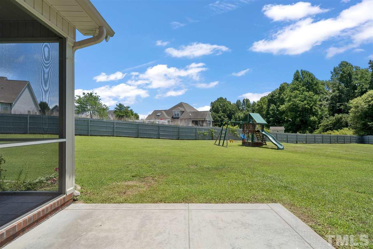 95 South Sunset Ridge Drive Willow Spring, NC 27592 - Photo 5 of 24 a view of a field with a tree in the background