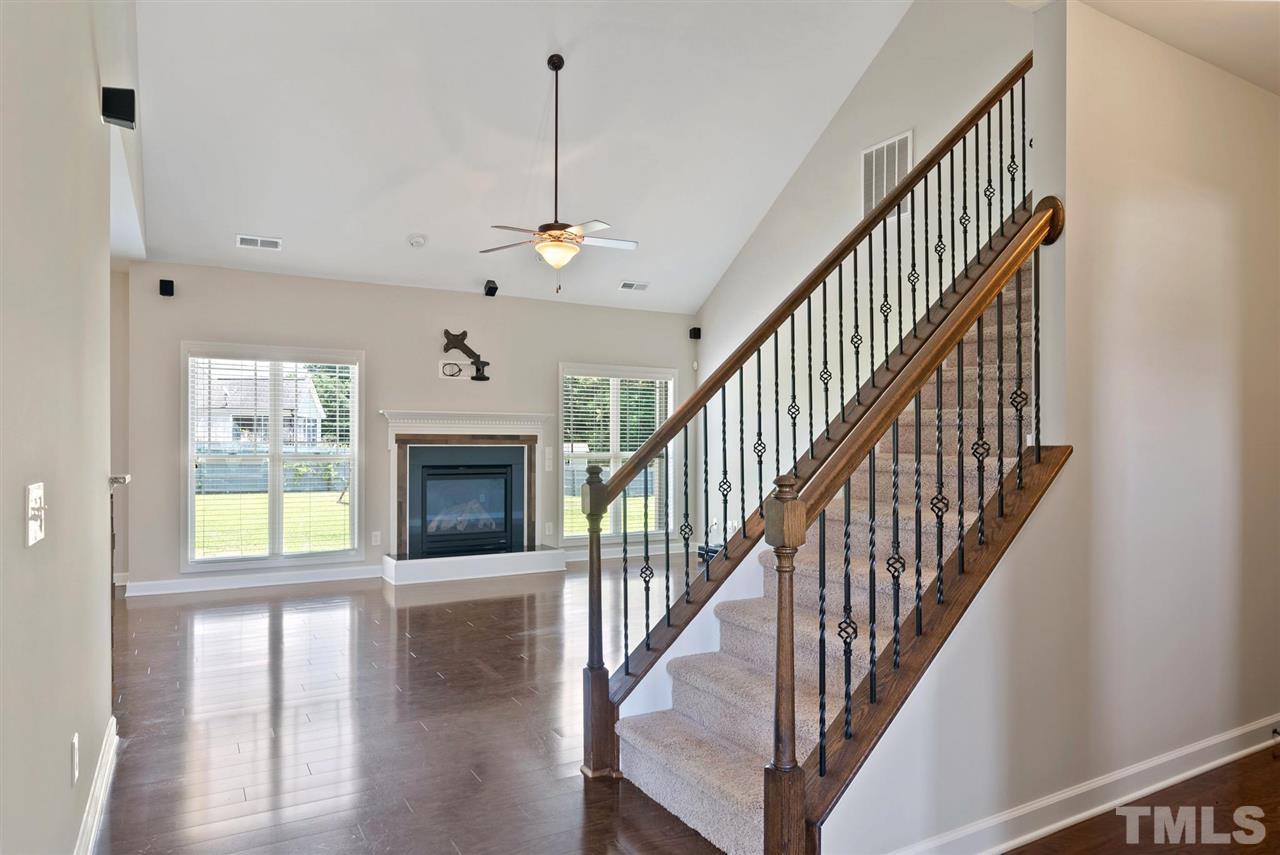 95 South Sunset Ridge Drive Willow Spring, NC 27592 - Photo 7 of 24 a view of a livingroom with wooden floor and staircase