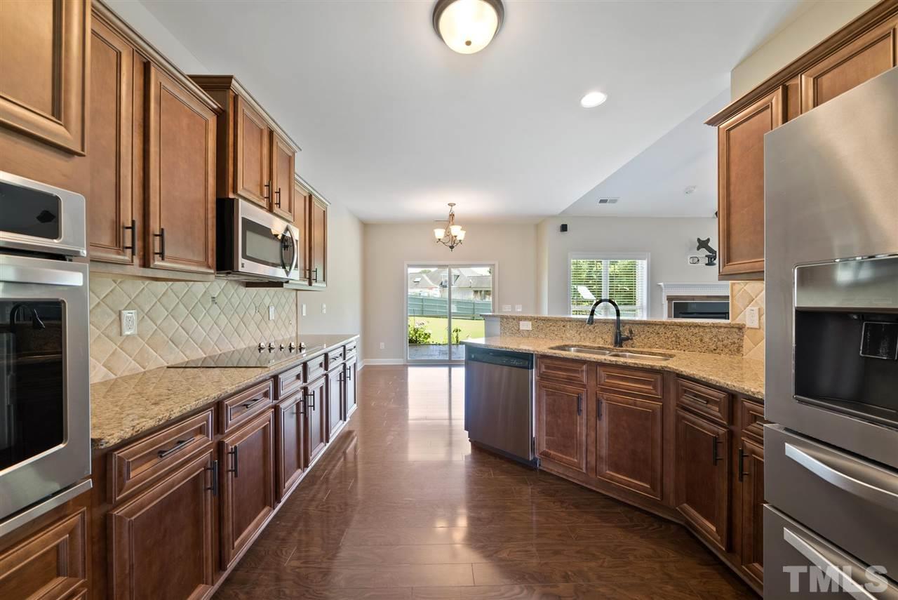 95 South Sunset Ridge Drive Willow Spring, NC 27592 - Photo 9 of 24 a large kitchen with stainless steel appliances lots of counter space and a sink