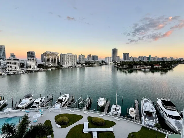 a view of a lake from a house with outdoor seating