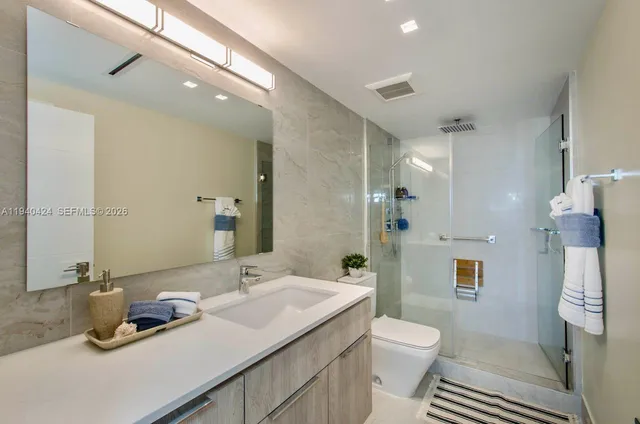 a bathroom with a sink toilet and shower