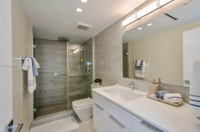 a bathroom with a sink toilet and shower