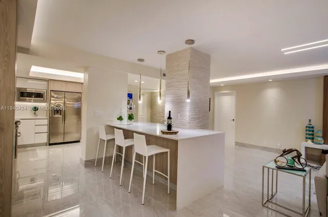 a kitchen with kitchen island a table and chairs in it