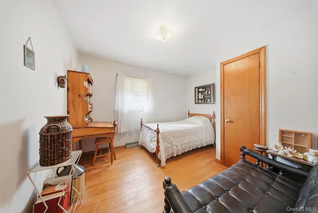 a bedroom with furniture and a wooden floor