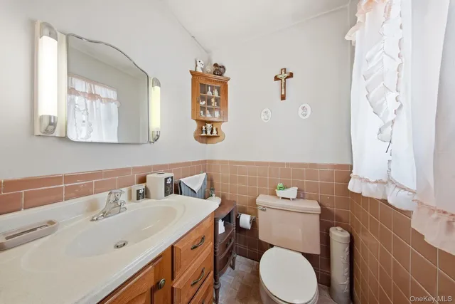 a bathroom with a toilet sink and mirror