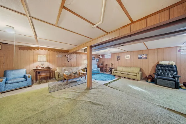 a living room with furniture a table and a chandelier