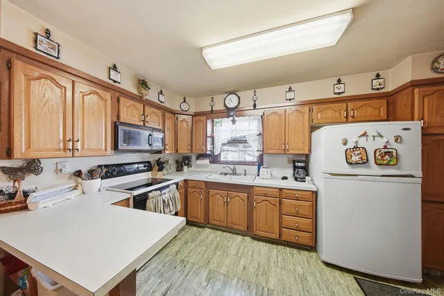 a kitchen with a sink a stove and cabinets