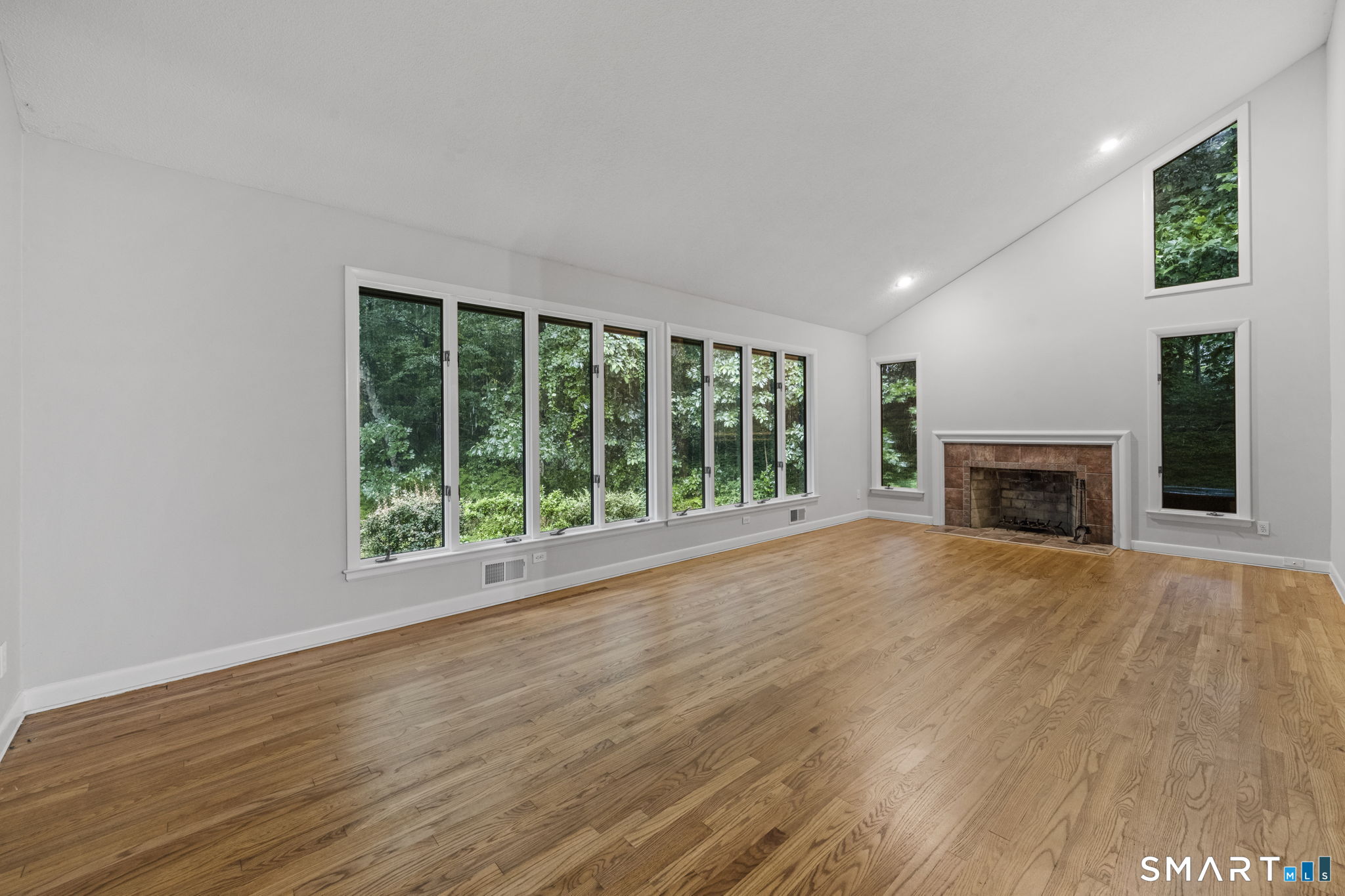 30 North Canton Road Simsbury, CT 06092 - Photo 7 of 38 High ceilings a fireplace and ample windows provide the perfect backdrop in this formal living room
