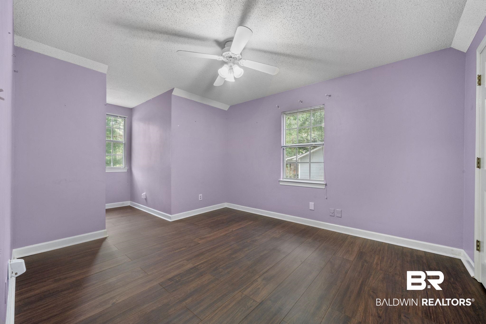 100 Montclair Loop Daphne, AL 36526 - Photo 36 of 39 Spare room with a textured ceiling, dark wood-type flooring, and ceiling fan
